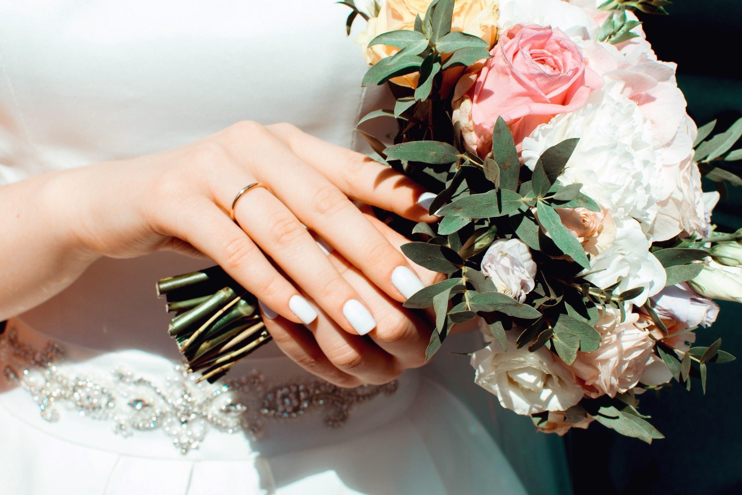 image of a bride holding wedding flowers